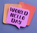 Paper note with phrase World Hello Day on color background, top view