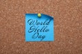 Paper note with phrase World Hello Day pinned to cork board Royalty Free Stock Photo
