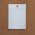 Paper note with pushpin on cork board background Royalty Free Stock Photo
