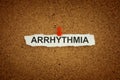 A paper note with the word Arrhythmia on it pinned to a cork board