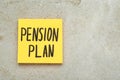 Paper note with words Pension Plan on light textured table, top view. Space for text Royalty Free Stock Photo