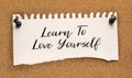 Paper note written with LEARN TO LOVE YOURSELF inscription on cork board Royalty Free Stock Photo