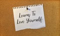 Paper note written with LEARN TO LOVE YOURSELF inscription on cork board Royalty Free Stock Photo