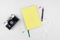 Paper notebook on a white background with vintage camera and office props