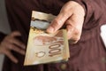 Paper notes from Canada. Dollar. Front view of old woman`s hand