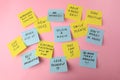 Paper notes with life-affirming phrases on pink background