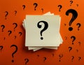 Paper notes with question marks on orange background, flat lay. Space for text Royalty Free Stock Photo