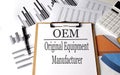 Paper with OEM Original Equipment Manufacturer on a chart background, Business