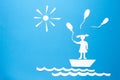 Paper origami girl in boat with balloons. Free state concept. Origami sun, sea waves, boat and girl on blue background Royalty Free Stock Photo