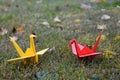 Paper origami in nature Cranes in the grass.