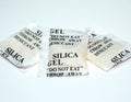 Paper packets of silica gel. Desiccant silica gel on white background Royalty Free Stock Photo