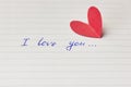 Paper page of notepad with sign I love you and red paper heart