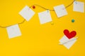 Paper, paper clips, heart and rope on a yellow background, with space for text Royalty Free Stock Photo