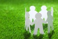 Paper people chain making circle on green, space for text. Unity concept Royalty Free Stock Photo