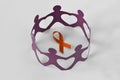 Paper people in a circle around orange ribbon on white background - Concept of leukemia awareness, kidney cancer Royalty Free Stock Photo