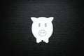 Paper piggy bank on black wood background. Saving money concept