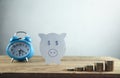 Paper piggy bank with stack of coins. Save your money Royalty Free Stock Photo