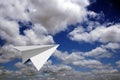 Paper plane flying in blue skies