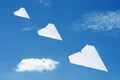 Paper plane flying over clouds with blue sky. Royalty Free Stock Photo