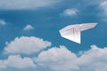 Paper plane flying over clouds with blue sky. Royalty Free Stock Photo