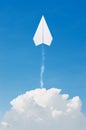 Paper plane flying up, over clouds with blue sky. Royalty Free Stock Photo