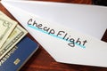 Paper plane with words cheap flight. Royalty Free Stock Photo