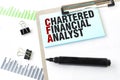 Paper plate, marker, diagram, chart and office tools. Text CHARTERED FINANCIAL ANALYST