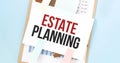 Paper plate with text Estate Planning. Diagram, notepad and blue background Royalty Free Stock Photo