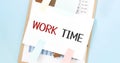 Paper plate with text work time. Diagram, notepad and blue background Royalty Free Stock Photo