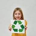 Paper with recycle sign in hands of little girl Royalty Free Stock Photo