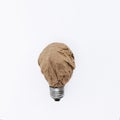 paper recycling ideas concept. Crumpled craft paper in the form of a light bulb. Royalty Free Stock Photo