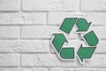 Paper recycling symbol on brick wall Royalty Free Stock Photo