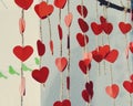 Paper red hearts on strings from hemp