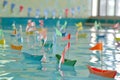 paper regatta with miniature flags in a swimming pool Royalty Free Stock Photo