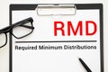 Paper with Required Minimum Distributions RMD on a table Royalty Free Stock Photo