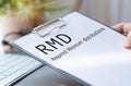 Paper with Required Minimum Distributions RMD on a table Royalty Free Stock Photo