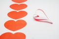 Paper and ribbon shaped as hearts on white background, valentine