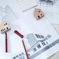 Paper rolls, construction drawings, calculators and wooden house models on concrete floors Royalty Free Stock Photo