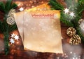 Paper sheet with german text Wunschzettel, that means wish list, between fir branches, cinnamon stars and Christmas decoration on Royalty Free Stock Photo