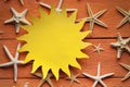 Paper sheet in the shape of the sun and shells Royalty Free Stock Photo