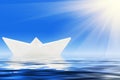 Paper ship and blue water Royalty Free Stock Photo