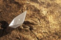 Paper ship on the dried ground