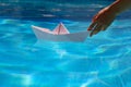 Paper ship in hand. Tourism and traveling, travel dreams vacation holiday, sailing adventure. Hand and paper boat.