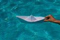 Paper ship and ocean water. Tourism and traveling, travel dreams vacation holiday, sailing adventure. Paper boat sailing Royalty Free Stock Photo