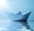 Paper ship in water and sunny blue sky Royalty Free Stock Photo