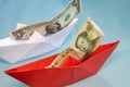paper ships with US and Chinese banknotes, one dollar and one yuan, Economic war, Business and financial concept Royalty Free Stock Photo