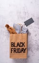 Paper shopping bag with with Black Friday text, blank price tag top view flat lay Royalty Free Stock Photo