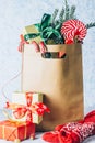 Paper shopping bag full of gift boxes Christmas ornamented