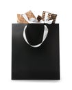 Paper shopping bag with handles full of gift boxes on white background Royalty Free Stock Photo