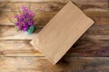 Paper shopping bag mockup with purple wildflowers Royalty Free Stock Photo